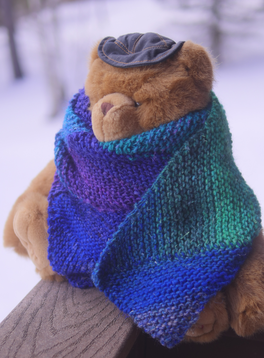 Teddy bear wearing scarf